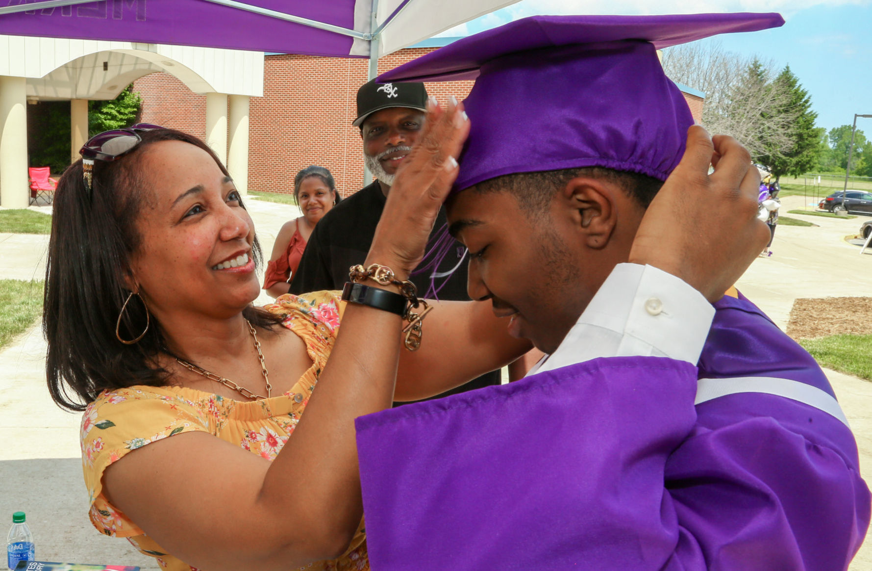 Merrillville High School seniors participate in a "drive-up" graduation